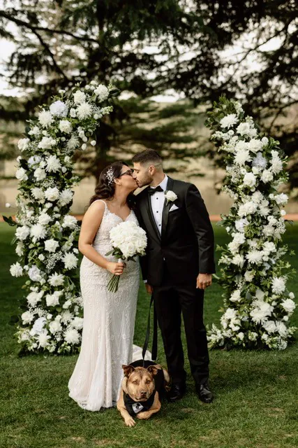 Chantelle and George's wedding ceremony with elegant white floral arrangements by The Red Poppy Florist.