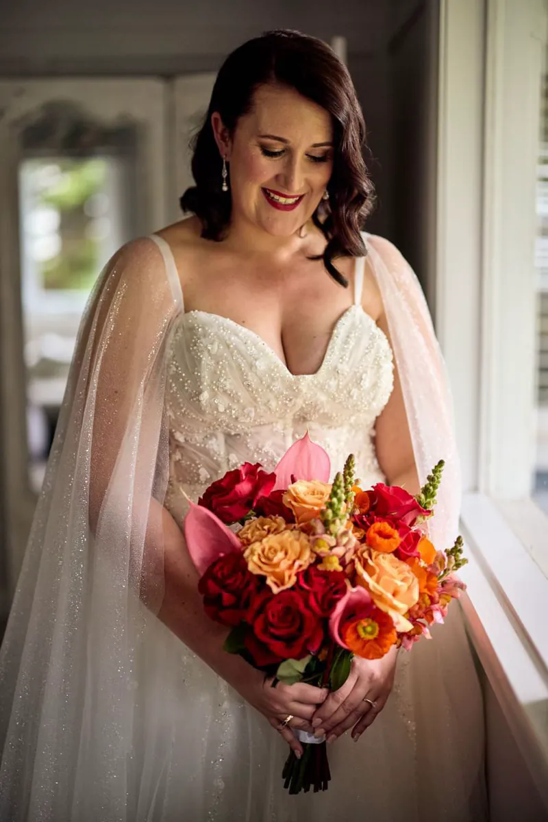 Colourful orange and pink bridal bouquet created by The Red Poppy Florist.